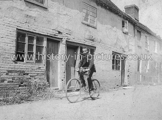 E P Digby cycling through Goldhanger, Essex. c.1915